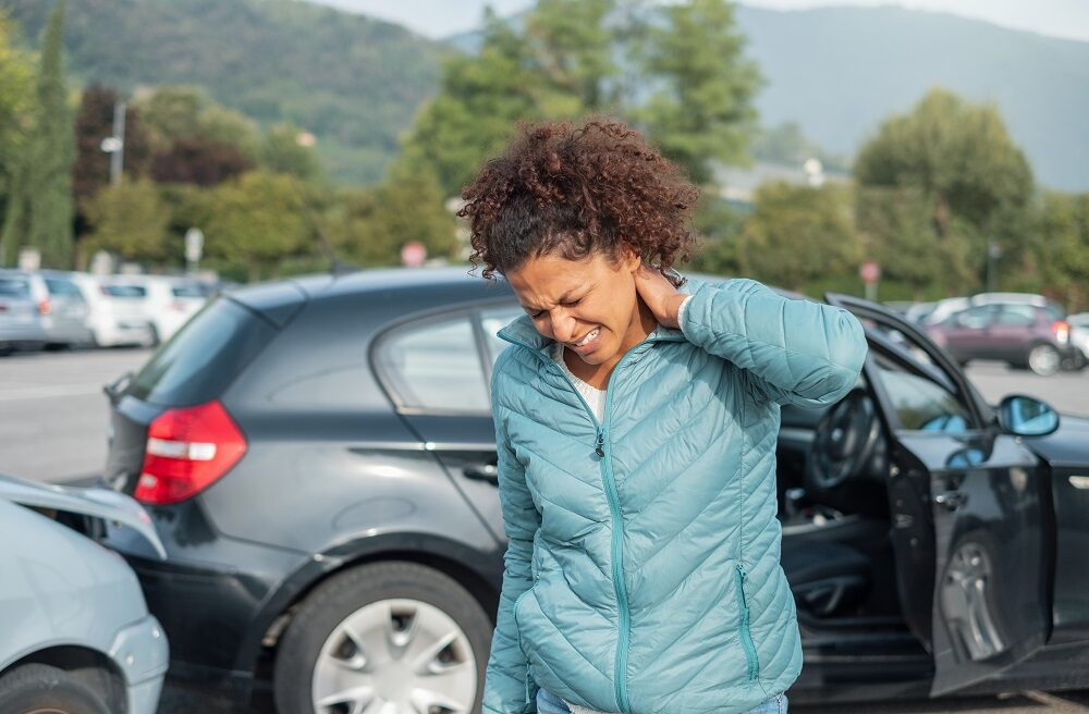 the woman is suffering from a severe neck pain due to a car accident
