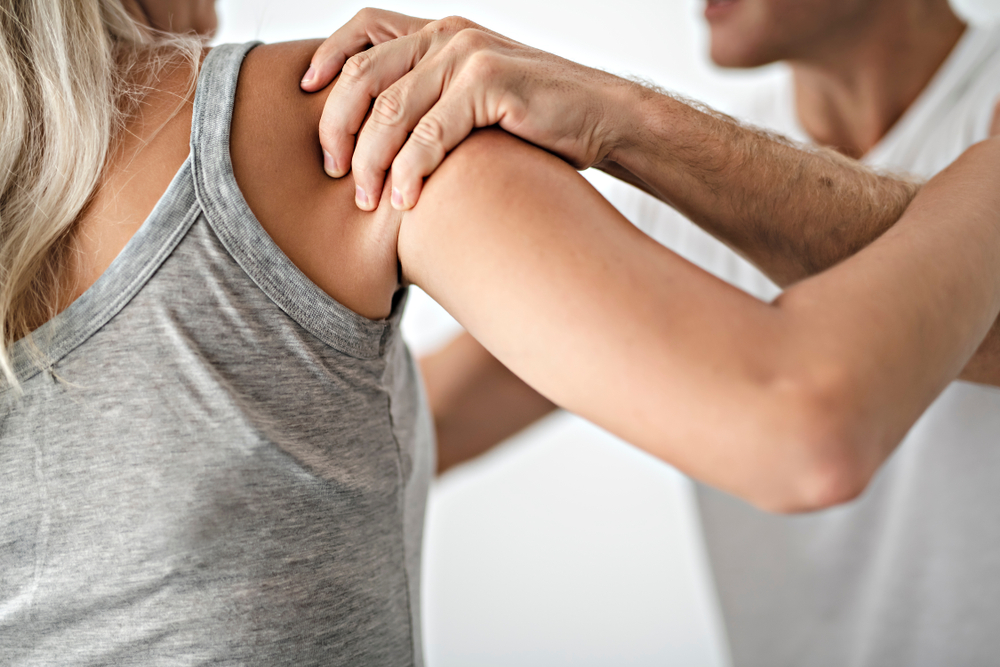A close-up of a shoulder examination highlighting common accident-related strain and the importance of chiropractic care for healing - Auto Accident Chiropractor in Parkland